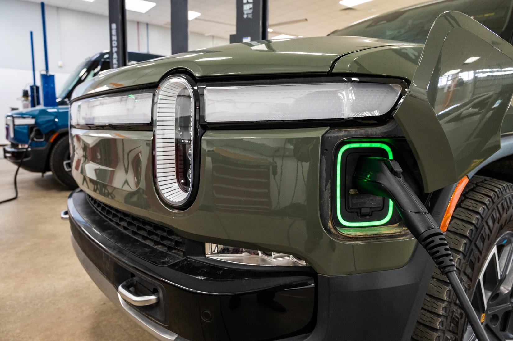 Rivian electric vehicles at Olive-Harvey College for the EV Technician Apprenticeship Program, showcasing hands-on training in electric car repair.