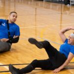 A female athlete prepares to hit a volleyball during training, embodying the spirit of adaptive sports.