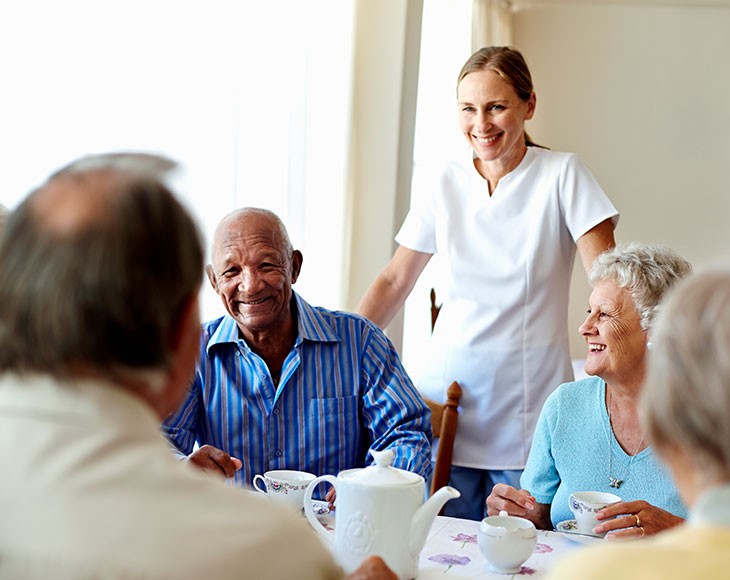 Adult care worker assisting senior, illustrating Georgia Long Term Care Background Check Program compliance for staff safety and patient protection.