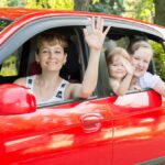 A happy mother and her children are enjoying their new free car.