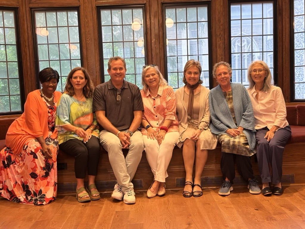 Diverse group of individuals in a brightly lit room, smiling and engaged, representing the Encore Transition Program cohort.