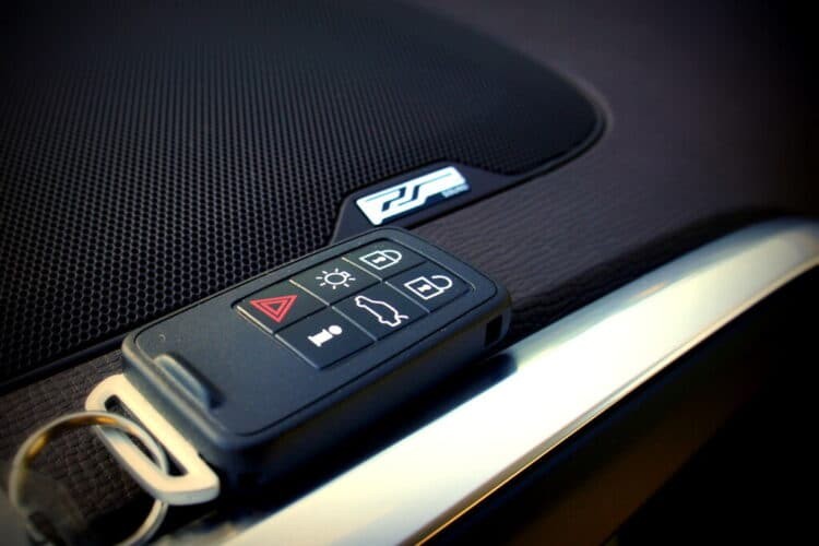 Modern car key fob with buttons for lock, unlock, and trunk release.