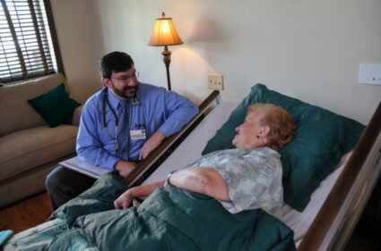 Doctor discussing care options with a patient, highlighting the differences between hospice and palliative care