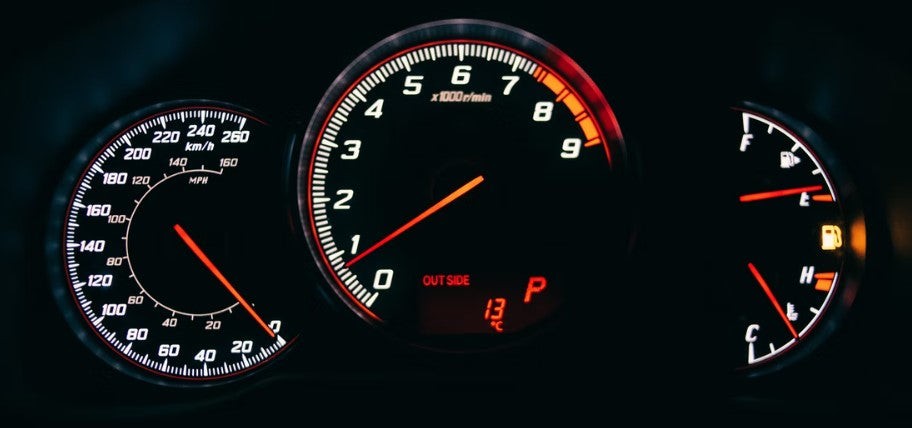 Modern car instrument cluster displaying various gauges and digital information