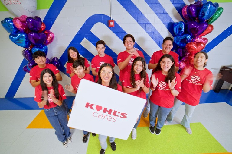 Group of children smiling and engaged in an activity at a Boys & Girls Club, showcasing the positive impact of Kohl's Cares support.